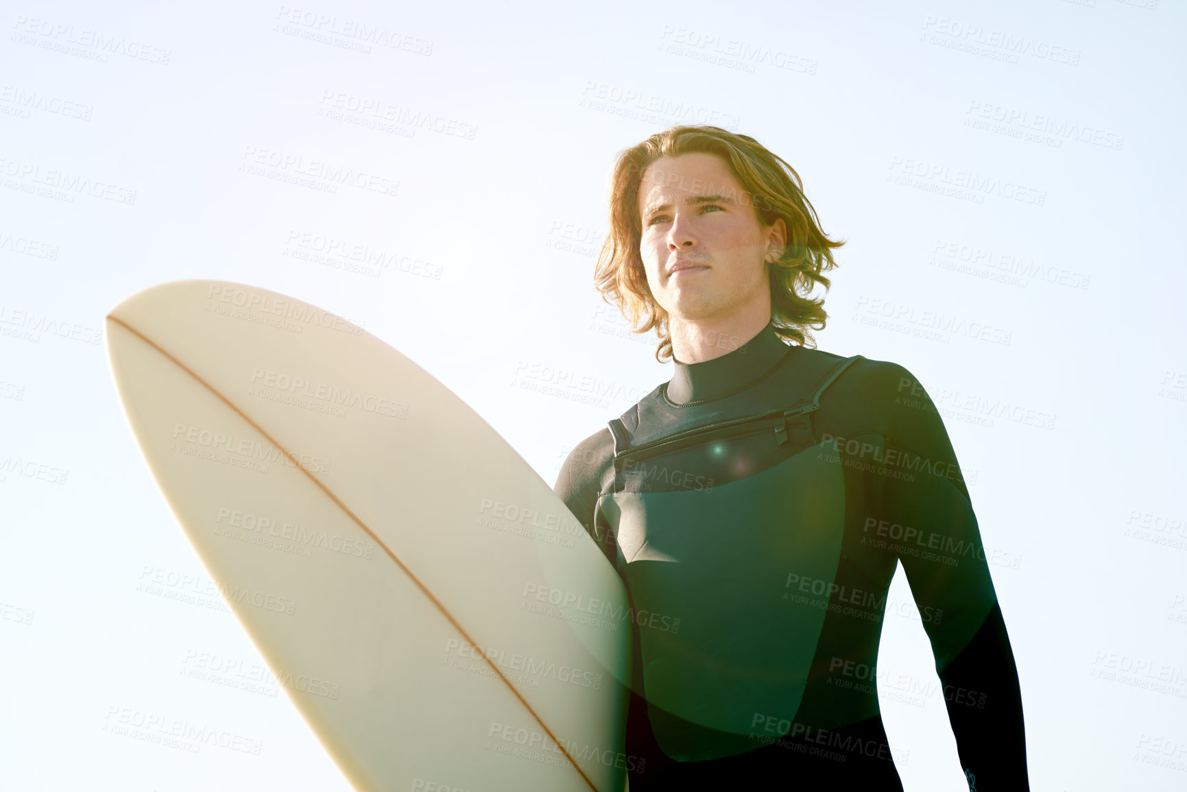Buy stock photo Thinking, surfer and man with surfboard at beach for water sports, adventure and surfing. Blue sky, nature and person by ocean, sea and outdoor for holiday, vacation and hobby on weekend in Portugal