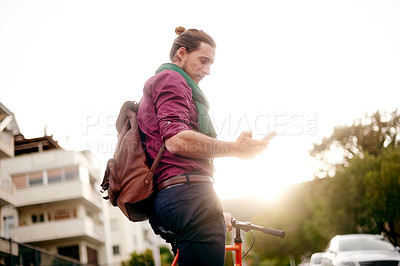 Buy stock photo Location, phone or man on bike in city for eco friendly transport, job appointment or travel. Search, texting or male designer in urban town with address, mobile app or bicycle for online directions