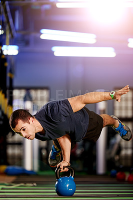 Buy stock photo Fitness, man and handstand with kettlebell at gym for calisthenics, strength training or stability. Athlete, night and balance on equipment at sports club for muscle growth, endurance or coordination
