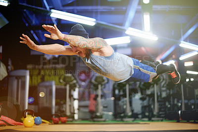 Buy stock photo Air, jump and man in gym for push up, workout and exercise for fitness, health and strong core. Calisthenics, fly and athlete training on floor in studio for balance, stability and acrobatics skills