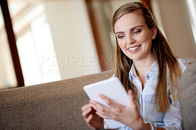 Buy stock photo Home, smile and woman with tablet, online reading and chatting with entertainment, app and email. Apartment, tech and person on couch, connection and message to contact, ebook and communication