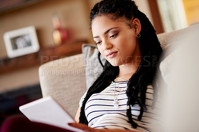 Buy stock photo Living room, woman and relax with tablet for online app, communication or reading ebook. African person, home and digital technology for social media, check email or blog post on internet on weekend