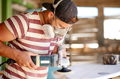 Buy stock photo Production, man and sanding surfboard in workshop for manufacturing process, design and shape. Surf, factory and person with electric tools to polish foam, grinder and maintenance with respirator