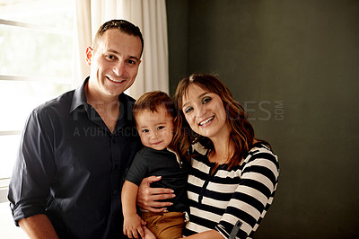 Buy stock photo Portrait, happy family and parents in home with kid for love, care and carrying toddler for bonding. Mother, father and child in apartment for support, connection and smile together in Germany
