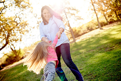 Buy stock photo Mom, spin girl and happy at park with game, bonding and child with love, care and summer in nature. People, mother and daughter in garden with smile, swing or play for family fun in New Zealand