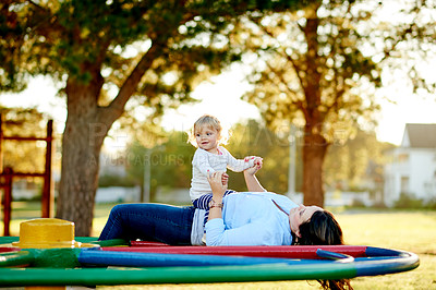 Buy stock photo Family, playing and child with mom, playground or holding hands on merry go round, bonding and love. Outdoor, game and break with girl on weekend, childcare and happy with toddler, woman and daughter