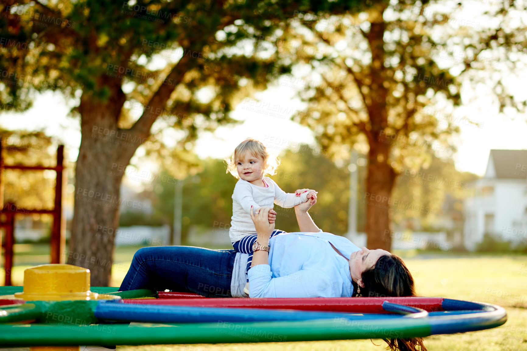 Buy stock photo Family, playing and child with mom, playground or holding hands on merry go round, bonding and love. Outdoor, game and break with girl on weekend, childcare and happy with toddler, woman and daughter
