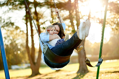 Buy stock photo Playing, mom and swing with child, playground or affection for toddler in nature or happy with girl. Outdoor, woman and fun with daughter on weekend, game and childcare on holiday, family and park