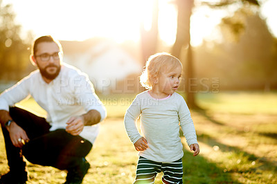Buy stock photo Parent, watching kid and play in park, bonding together and family time in summer adventure. Freedom, father and daughter in grass field with supervision, youth lifestyle or happy moment in spring.