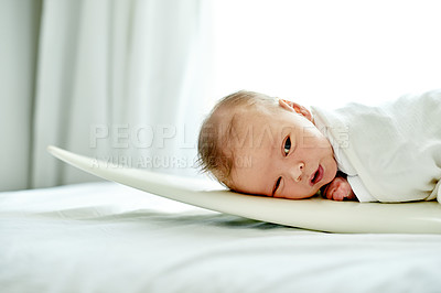 Buy stock photo Baby, bed and lying on board for rest, break or morning with comfort or peace on duvet in home. Newborn child, infant or kid relaxing on surfboard for innocent youth or childhood development in house