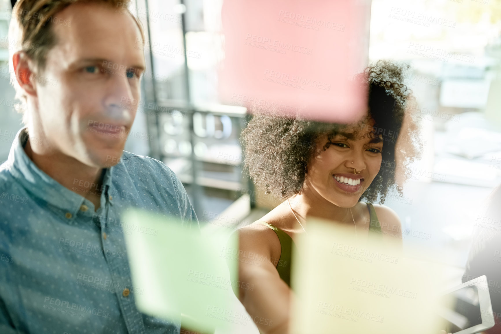 Buy stock photo Solution, reading or people with sticky note on glass for brainstorming, tasks or project strategy. Smile, collaboration and creative designers in meeting for startup, teamwork and planning ideas