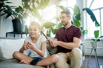 Buy stock photo Hair braid, happy girl and man in living room with bonding, helping and support for morning routine. Home, daughter and single parent on couch with grooming, together and getting ready for school.