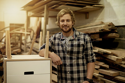 Buy stock photo Man, portrait and smile in workshop for carpentry, furniture repair or manufacturing with timber. Carpenter, side table and male person with trade in woodworking industry, craftsman and lumber flare