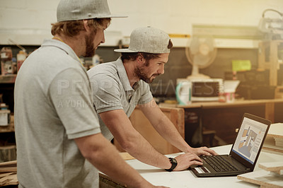 Buy stock photo Teamwork, planning and men in workshop with laptop, brainstorming or feedback on project. Discussion, blueprint and contractor in store with tech, production update or research for renovation vision.