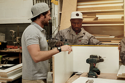 Buy stock photo Carpentry, collaboration and measure with men in workshop together for manufacturing or production. Creative, design and measuring tape with woodwork team in factory for cabinetmaking or joinery