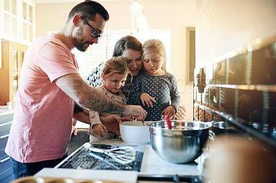 Buy stock photo Parents, children and learning to bake in kitchen, help and bonding together with family. Kids, dad and mix ingredients with mother in home, teaching recipe and cooking for development with girls
