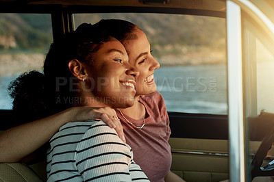 Buy stock photo Travel, lesbian couple and bonding in car with hug, road trip break, and sightseeing ocean together. Love, lgbt women and happy with embrace in vehicle for journey pause, explore scenery or adventure