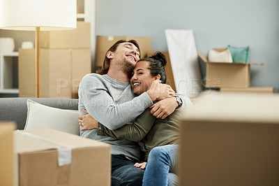 Buy stock photo New home, happy and couple hug on sofa to relax after moving, relocation or real estate purchase. Homeowners, bonding and man with woman with embrace, love and support for property, mortgage or house