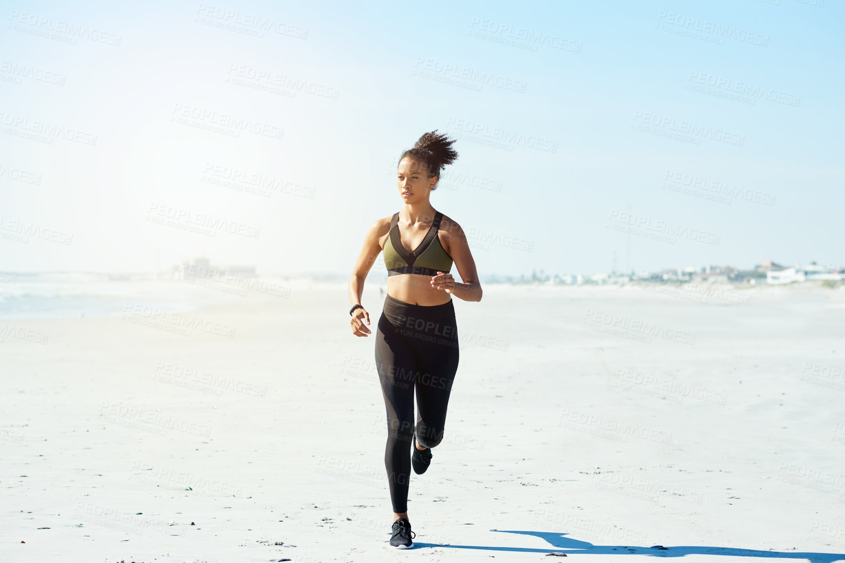 Buy stock photo Blue sky, fitness and running with woman on beach for cardio training or morning workout. Exercise, health and wellness with African athlete or runner on space outdoor for challenge or improvement