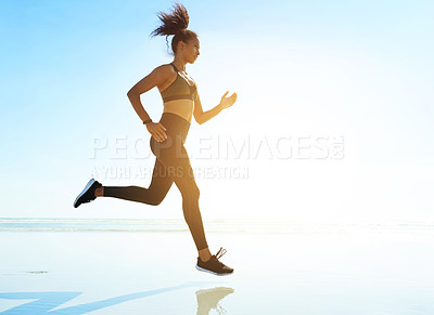 Buy stock photo Fitness, woman and running by sea for workout, body wellness and health with space. Beach, runner and cardio exercise outdoor for endurance challenge, training and energy with flare in nature