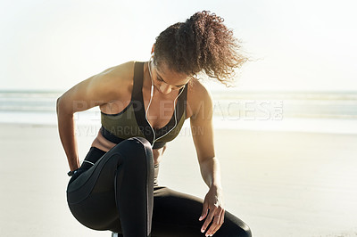 Buy stock photo Earphones, fitness and rest with woman on beach for break from cardio training or workout. Exercise, fatigue and music with African athlete or runner outdoor for recovery from marathon preparation