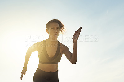 Buy stock photo Woman, running or fitness with blue sky or sunset for workout, exercise or outdoor training. Low angle, female person or runner with flare for sprint, cardio practice or health and wellness on space