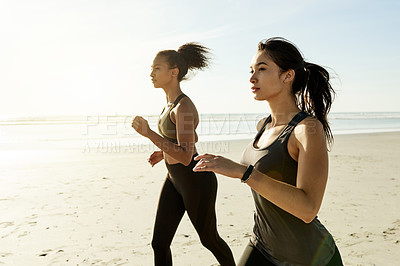 Buy stock photo Fitness, women and friends running by sea for workout, training and body health outdoor in nature. Team, runners and exercise at beach together for endurance, cardio and jog for sports with space