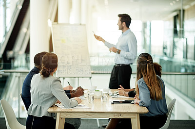Buy stock photo Businessman, meeting or presentation with team by whiteboard in office for staff training. Male person, speaker or coaching with group of employees for company strategy, agenda or ideas in workplace