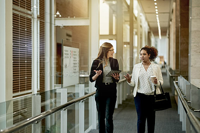 Buy stock photo Talking, business and women in office with tech, walking and consultation at law firm. Smile, appointment and female lawyers in lobby ready for meeting, discussion and legal help for civil court case