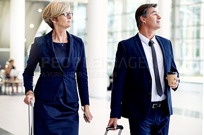 Buy stock photo Walking, travel and search with business people in airport lobby for departure time, suitcase or team. Conference trip, boarding pass and luggage with mature employees for layover and flight schedule