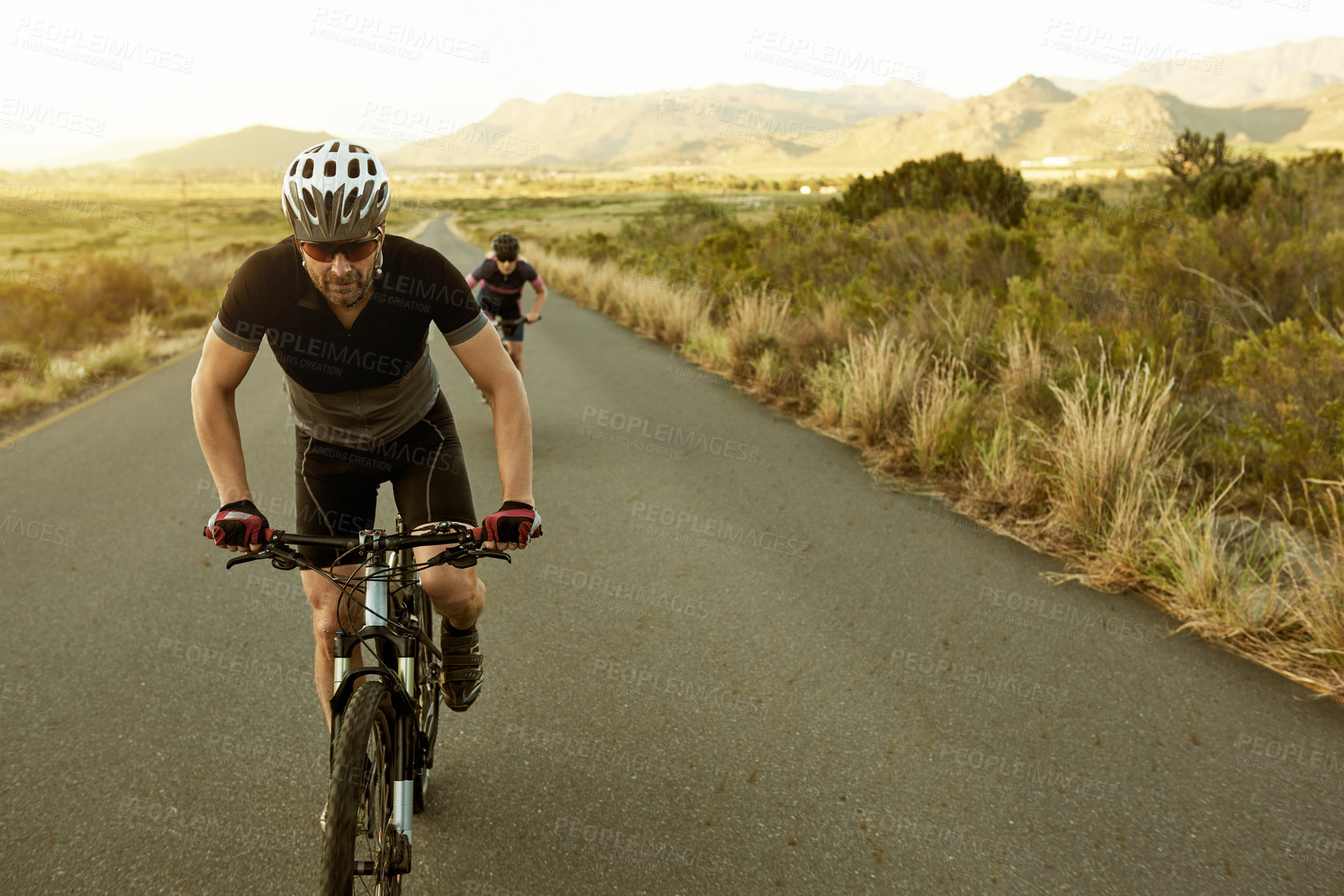 Buy stock photo Couple, fitness and road with bicycle in nature for mountain ride, exercise or outdoor workout. Active man, woman or cyclist with helmet on bike for cycling race or sport marathon in countryside