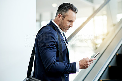 Buy stock photo Escalator, airport and businessman with phone for news, commute and arrival in lobby. Conference, professional or mature person on electric stairs on mobile app for flight schedule, trip or travel