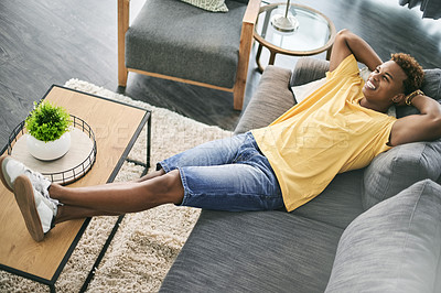 Buy stock photo Stretching, man and relax on couch, home or stress relief in lounge, happiness or calm in apartment. Above, African person or comfortable on sofa, positive mindset and rest on weekend, smile or break