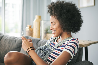 Buy stock photo Phone, relax and smile with woman on sofa in living room of home for online post or update. App, browsing and communication with happy African person in apartment for download or mobile chat