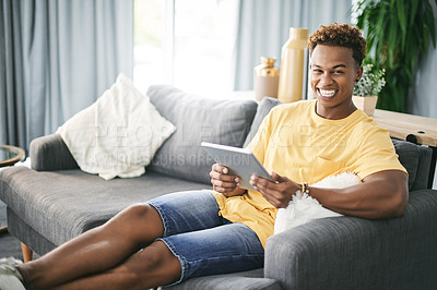 Buy stock photo Laughing, portrait and tablet with man on sofa in living room of home to search for social media review. App, break and funny with person reading information online for me time planning or research