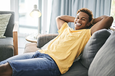 Buy stock photo Portrait, man and stretching on couch, home or stress relief in lounge, happy and calm in apartment. Pride, African person or comfortable on sofa, positive attitude or rest on weekend, smile or break