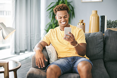 Buy stock photo Laughing, sofa and black man with phone for online chat, social media and funny message notification. Happy, relax and person on smartphone for website joke, meme and networking on mobile app in home