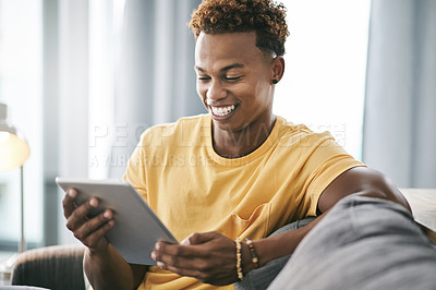 Buy stock photo Relax, smile and tablet with man on sofa in living room of home to search for social media review. App, break and weekend with happy person reading information online for me time planning or research