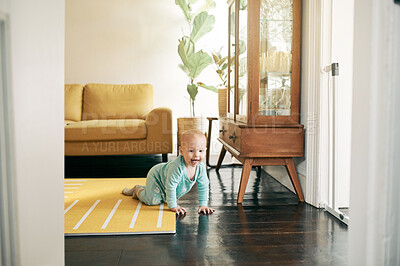 Buy stock photo Kids, growth and a baby crawling in the living room of a home during child development with curiosity. Children, cute and active with an adorable toddler or infant in a house to crawl on the floor
