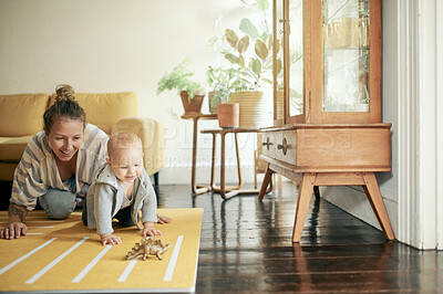Buy stock photo Baby, toy and mom playing with newborn on the floor of a house or home and bonding together. Care, motherhood and single parent or woman having fun with infant, child or kid with happiness