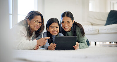 Buy stock photo Floor, relax and tablet with women in family home for streaming service, parental control and happy. Age rating movie, support and generations with grandmother, kid and mother in house for comedy