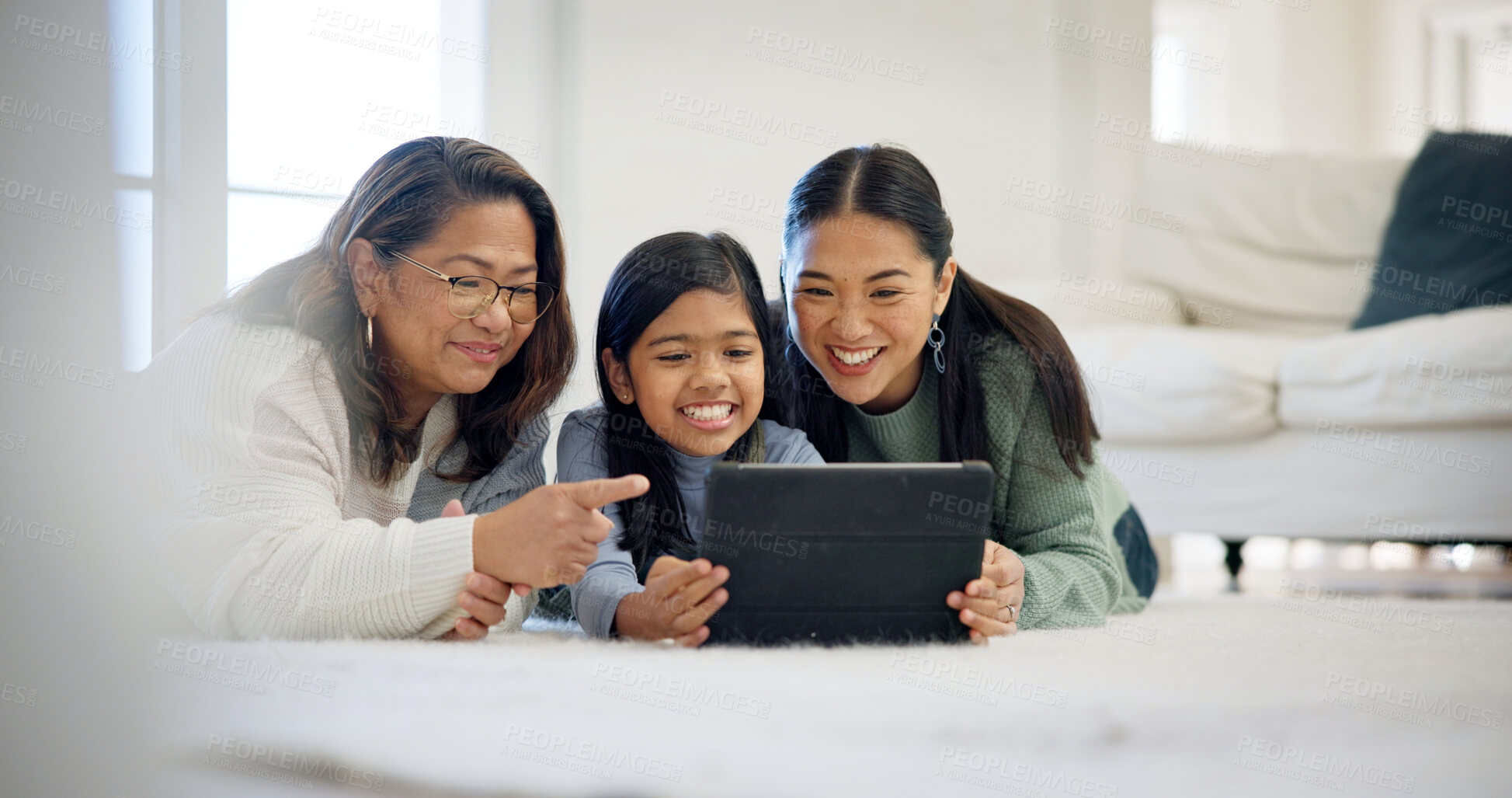 Buy stock photo Floor, relax and tablet with women in family home for streaming service, parental control and happy. Age rating movie, support and generations with grandmother, kid and mother in house for comedy
