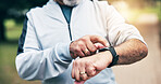 Senior, hands and checking time with watch in park for outdoor fitness or tracking performance. Elderly, male person or wristwatch with heart rate for monitoring cardio, health or wellness in nature