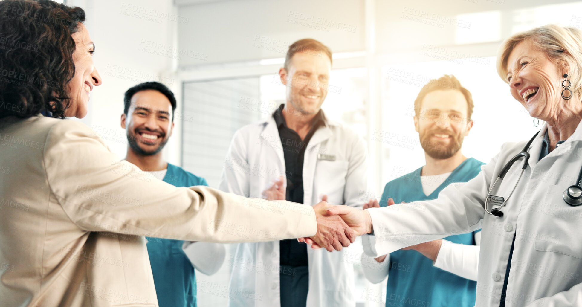Buy stock photo Doctor, happy people and handshake in hospital for healthcare agreement, funding or approval. Team, applause and shaking hands in clinic for partnership, medical grant and laughing with success