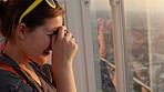 Beautiful young woman taking pictures while riding a ferris wheel