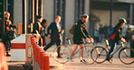 Multiple people,walking, cycling and driving through the city