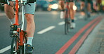 Closeup of a group of people cycling through a city together