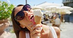 A carefree young woman enjoying ice cream while on holiday