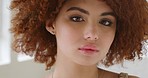 Beautiful redhead woman with a curly afro looking serious