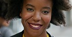 Young african woman with an afro smiling during a day in the city